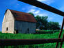An old barn in long grass in Madison County