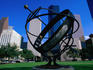 The Armillary Sphere; a modern sculpture in Sam Houston Park, surrounded by high-rises in the downtown area