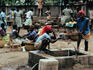 Women gathering drinking water from a well in the market place
