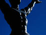 The statue silhouetted against a blue sky
