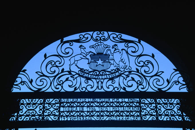 The royal crest and ornate detail of the wrought iron gates to Palacio de la Moneda, Santiago