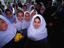 Young local schoolgirls in required uniform smile in Tehran