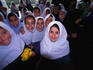 Young local schoolgirls in required uniform smile in Tehran