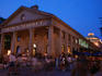 Crowds of people outside the Quincy Market building at night