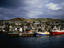 Boats docked in the harbour beneath a grey cloudy sky - Scotland