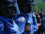 For your safety: Riot police in masks and carrying batons