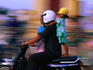 Dad takes the kids, perilously, through Phnom Penh on the back of the motorbike.