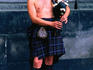 A busker in full regalia blowing his pipes in Edinburgh, Scotland
