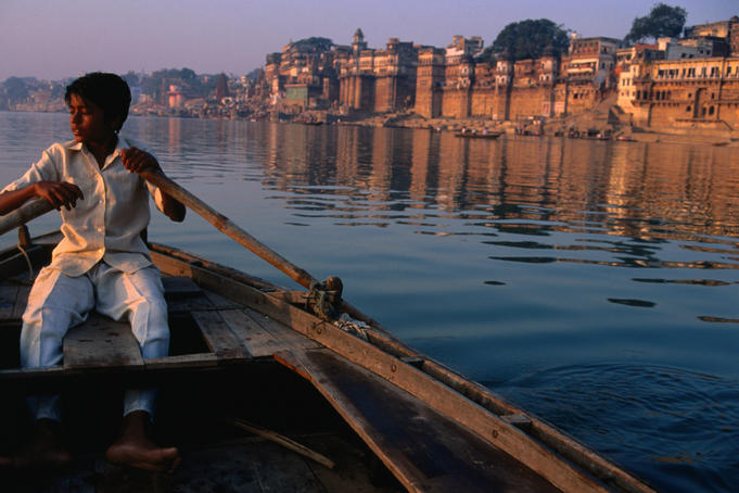 A young boatsman rows the sacred River Ganges in Varanasi.