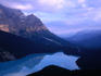Morning mists over the serene Peyto Lake, one of the world's most beautiful glacial lakes, in the Banff National Park.