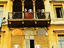 Persian carpets and washing hanging on apartment balconies.