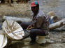 A local craftsman making decorated stools on the roadside near Mamou.