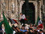 Soccer fans wearing and waving Italian flags on the Piazza del Duomo