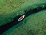 Small boat moored on estuary.