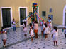 Children rehearse a maypole dance routine.