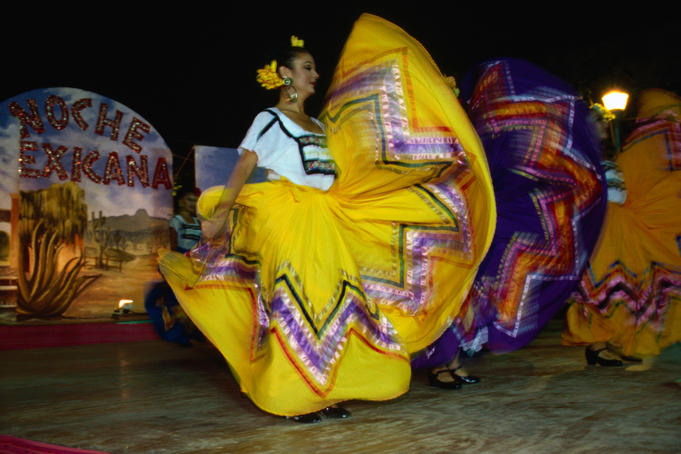 Dancers wearing a colourful costume performs at La Noche de Mexico festival.