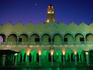 The arched facade of Plaza Mayor Palacio Municipal (1821) illuminated at night.