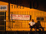 Taking a break outside the Tire Super Center, Old Winter Garden Road.