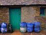 Lobster pots stacked by an out-house in the fishing port of Stromness.