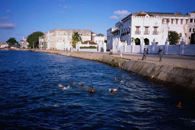 Young local boys from Zanzibar Town plunge into the Zanzibar Island waterfront.