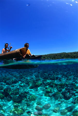 Local boys in canoe.