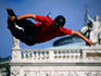 Roller-blader trick skating with Burgtheater in background.