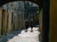 People walk along an uncrowded labyrinthine alleyway in the Old Town of Rhodes City, Rhodes Island Dodecanese