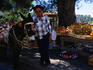 Stall owner and donkey rest in the shade of a large tree, Monchique.