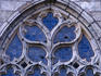 Detail of carving on a window of a stone church.