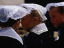 Women in traditional Breton costume watching the Fest Noz parade in Vannes.
