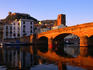 Pontevecchio bridge reflected in the River Temo with Castella Malaspina (castle) above the town, Bosa, Sardinia
