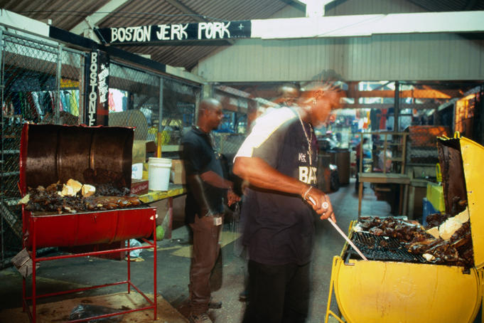 Cooking up jerk pork and chicken at the night market in Port Antonio, runaway slaves known as Maroons first " jerked " wild pigs, then cooked the meat over a " barbacoa ", from which comes the word barbeque