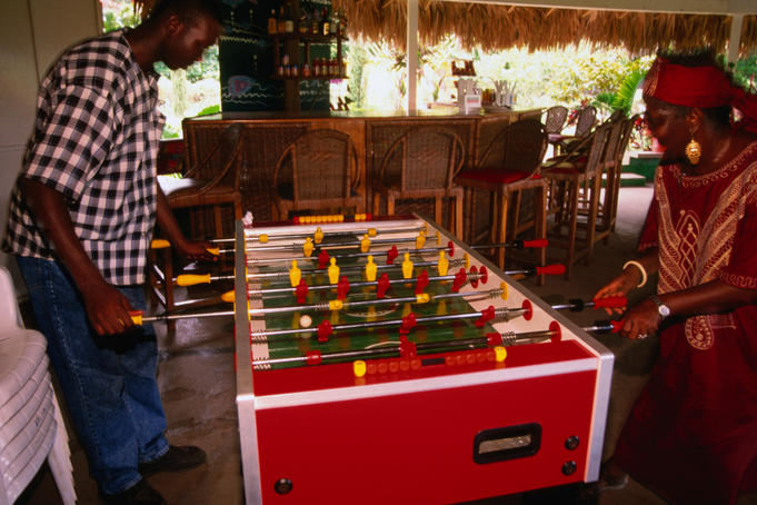 Having a game of " foosball " at a bar in Montego Bay