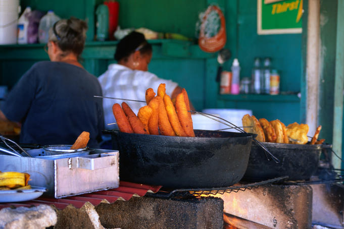 Chefs cleaning up while plantains and cod fish fritters or "bocallones" wait to be served in Pinones, near San Juan.