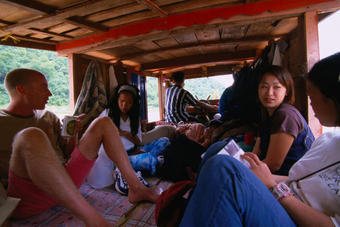 Travellers get a ride on a cargo boat up the Mekong River in Vientiane.