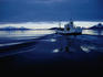 Fishing boat plowing through calm waters outside of Lofoten.