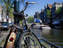 Bicycles chained to a post by a canal in the wallen, Amsterdam's red-light district.