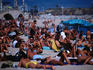 A crowd of sunbathers on Mar Bella beach in Barcelona