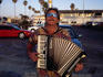 An accordian player busking on Ocean Beach in San Diego.