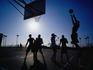 A late afternoon game of basketball on the Ocean Front walk in San Diego.