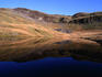 The calm waters of Llyn Ffridd ( lake ) reflect Y-Bwlch ( mountain ), Snowdonia National Park- Wales