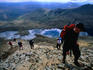 A group of hikers heading for Crib Goch with Llyn Teyrn ( lake ) behind them, Snowdonia National Park - Wales