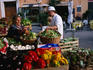 Red and yellow capsicum, egg-plants and other fresh produce at an outdoor fruit and vegetable stall in the Campo de' Fiori market