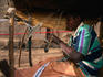 A seated weaver in his open air workshop at Mopti.
