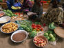 Vegetable vendors at the Timbuktu market sit patiently cross-legged ready to sell their wares.