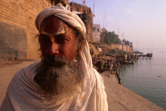 A peacful Sadhu, worshipper of Vishnu, sits quietly by the River Ganges in Varanasi.