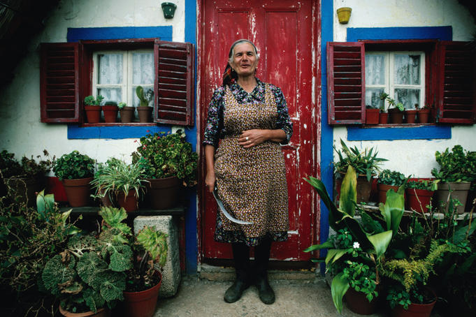 Woman standing in front of her house door.