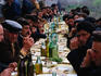 A group of happy Armenian men sit down to a meal and drinks in the area known as Nagorno-Karabakh, although this region has its own government administration it is not recognised by any government other than Armenia