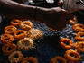 Making 'jalebis', one of the most popular Indian sweets. A sweet floury paste is squeezed into boiling oil in shapes and is deep fried.