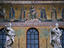 Mosaics and statues on the roof of Chiesa Santa Maria in Trastevere, Rome. The church is dedicated to the Virgin Mary and the mosaic frieze at the top of the facade portrays the presentation of gifts to the Virgin and Christ child, surrounded by a group o